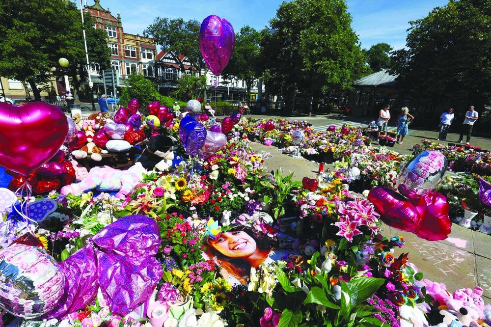
Flowers and balloons, left in tribute to Alice Dasilva Aguiar, Bebe King, and Elsie Dot Stancombe, are pictured outside the Town Hall in Southport, northwest England. – AFP 