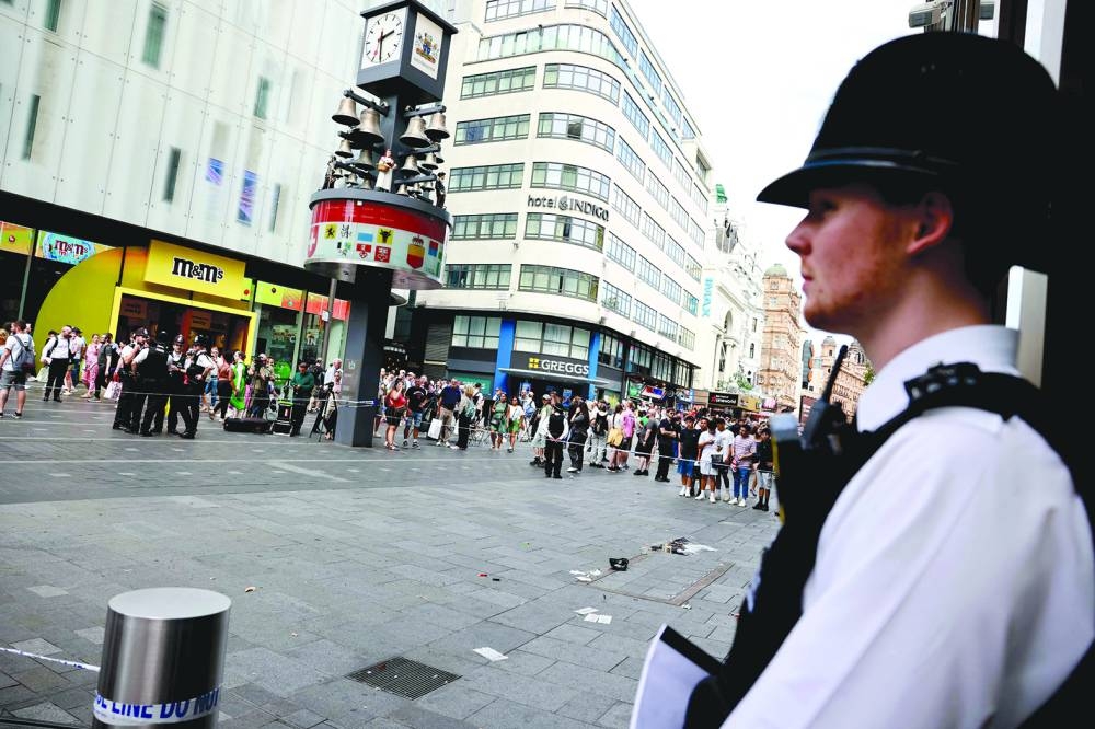 A photograph taken yesterday shows a police officer standing by a cordoned off area in Leicester square, London.