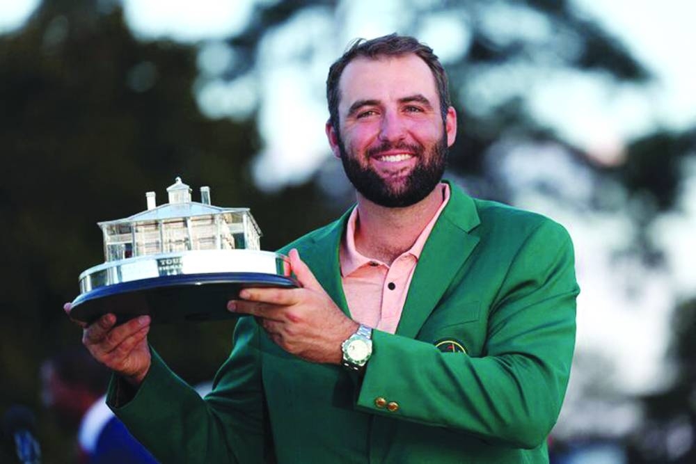Scottie Scheffler of the US celebrates with his green jacket and the trophy after winning The Masters at Augusta National Golf Club, Augusta, Georgia. (Reuters) 