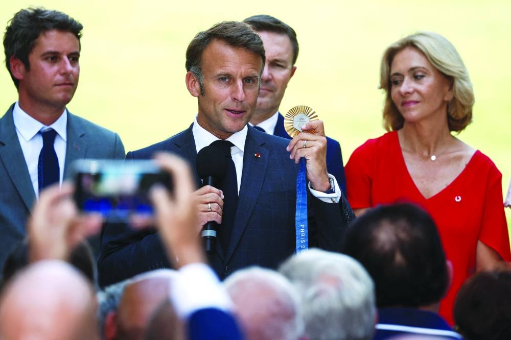 French President Emmanuel Macron with representatives of stakeholders who contributed to the organising and hosting of the 2024 Paris Olympic Games, at the Elysee Palace in Paris, yesterday. (Reuters)
