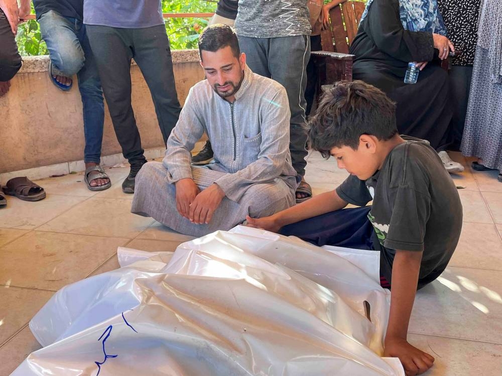 Mourners react near the body of a Palestinian who was killed in an Israeli strike, at Nasser hospital in Khan Younis in the southern Gaza Strip, pn Tuesday. REUTERS