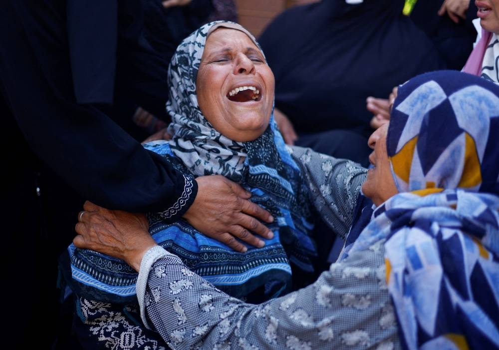 Women mourn Palestinians killed in Israeli strikes, at Nasser hospital in Khan Younis in the southern Gaza Strip, on Tuesday. REUTERS