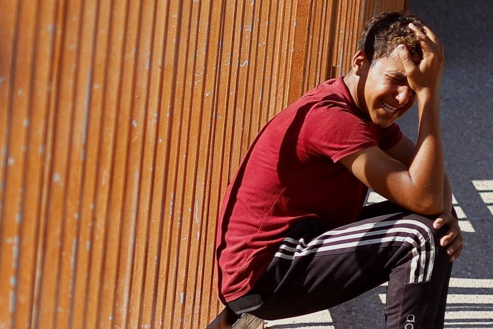A Palestinian reacts as he mourns Palestinians killed in Israeli strikes, at Nasser hospital in Khan Younis in the southern Gaza Strip, on Tuesday. REUTERS