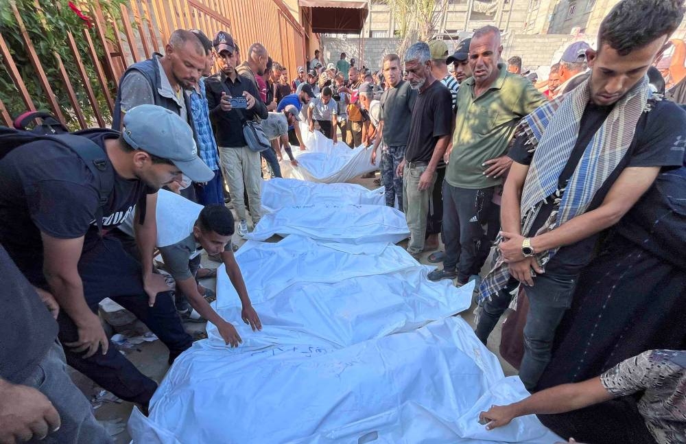 Mourners gather near the bodies of Palestinians killed in Israeli strikes, at Nasser hospital in Khan Younis in the southern Gaza Strip, on Tuesday. REUTERS