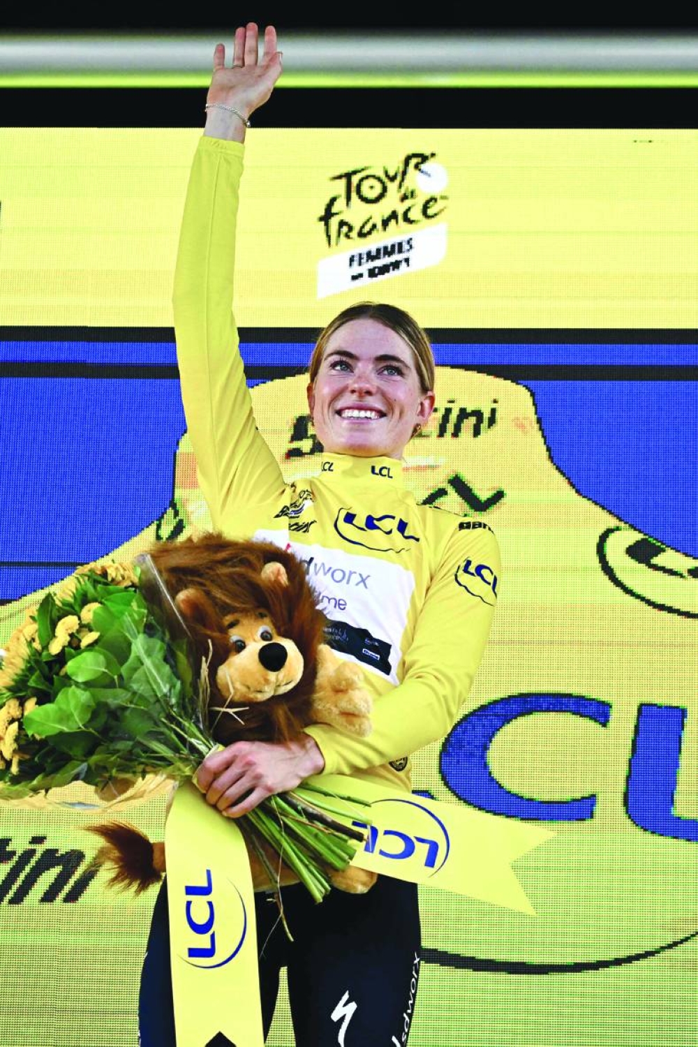 Demi Vollering celebrates on the podium with the overall leader’s yellow jersey after stage 3 of the Women’s Tour de France in Rotterdam on Tuesday. (AFP) 