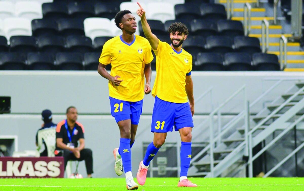 Al Gharafa’s Ferjani Sassi (right) celebrates after scoring against Shabab Al Ahli during the AFC Champions League Elite Preliminary Stage 2 match at the Al Bayt Stadium. 