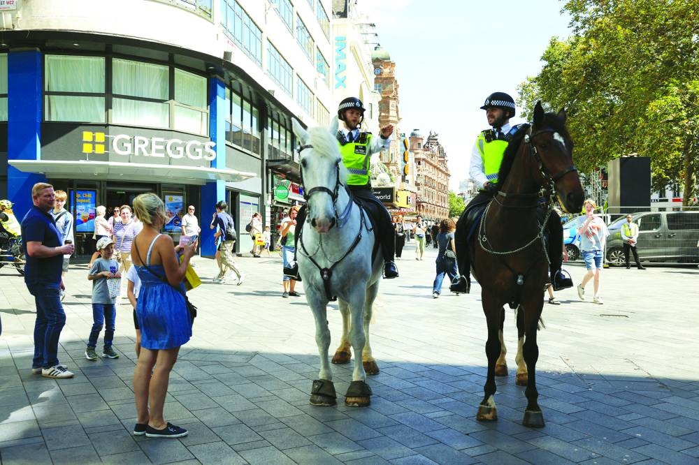 Mounted police are seen on patrol at Leicester Square, in London.