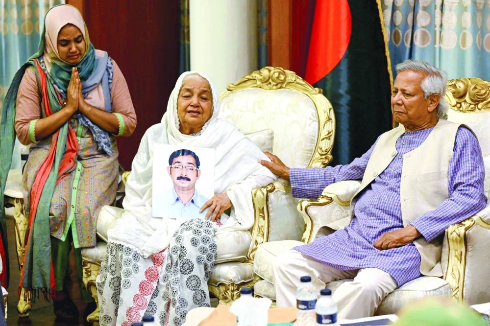 
Nobel laureate and chief adviser of Bangladesh’s new interim government Mohamed Yunus (right), consoles Mayer Daak founder Hazera Khatun as she holds a portrait of her son Sajedul Islam Sumon, who went missing during the tenure of ousted Prime Minister Sheikh Hasina, in Dhaka, yesterday. 