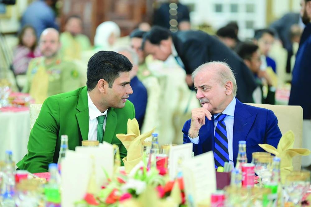 Prime Minister Shehbaz Sharif having a word with Arshad Nadeem during the state banquet at the PM House in Islamabad yesterday. 