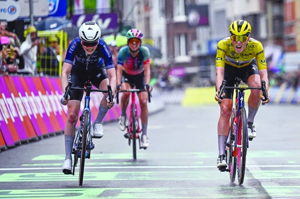Fenix-Deceuninck team‘s Dutch rider Puck Pieterse (left and below) crosses the finish line to win followed by Team SD Worx - Protime’s Dutch rider Demi Vollering (right) and Canyon//SRAM Racing team’s Polish rider Katarzyna Niewiadoma during the 4th stage of the third edition of the Women’s Tour de France cycling race, a 122.7km between Valkenburg and Liege, on Wednesday. (AFP) 