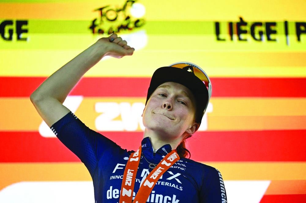 Fenix-Deceuninck team 's Dutch rider Puck Pieterse celebrates on the podium after the 4th stage (out of 8) of the third edition of the Women's Tour de France cycling race, a 122.7 km between Valkenburg and Liege, on August 14, 2024. (Photo by JULIEN DE ROSA / AFP)