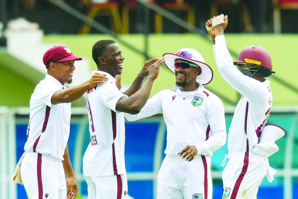 Shamar Joseph (second left), Gudakesh Motie (left) and Kavem Hodge (third left) of West Indies celebrate the dismissal of David Bedingham of South Africa during the first day of the second Test at Guyana National Stadium in Providence, Guyana, on Thursday. (AFP)