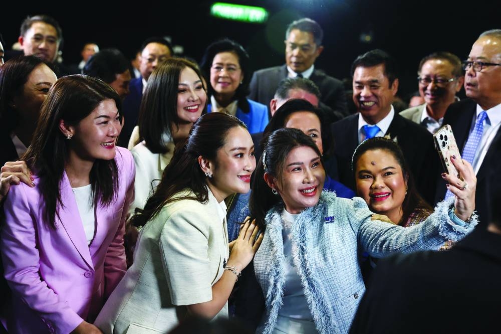 Pheu Thai Party’s leader Paetongtarn Shinawatra poses for a selfie after the Thai parliament confirms her as the country’s next prime minister, in Bangkok. 