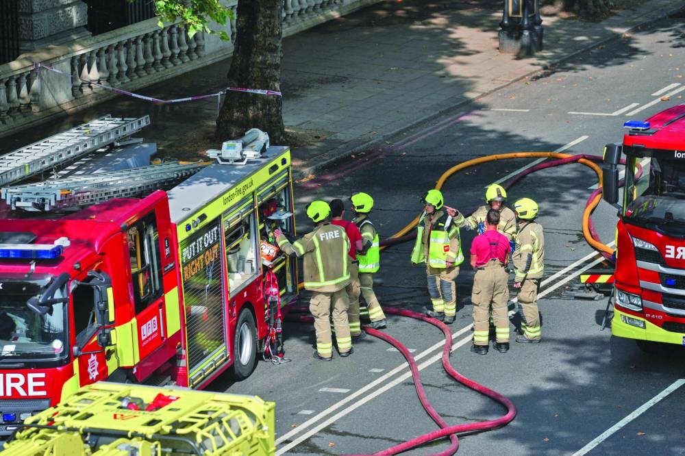 
Firefighters work at the scene of a fire at Somerset House in London. 