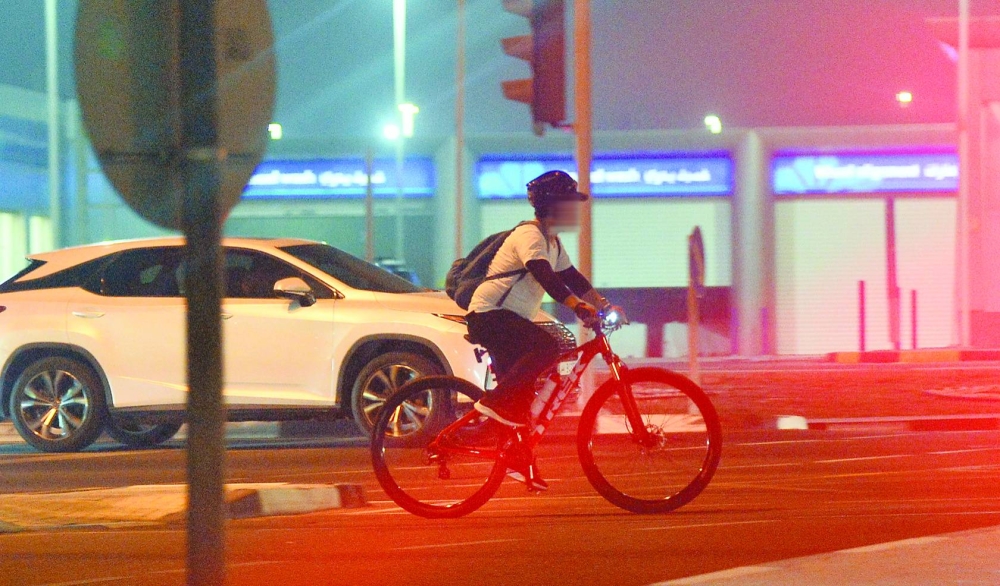 A law-abiding cyclist on a Doha road.