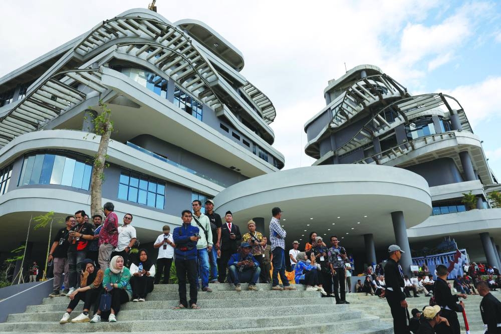 
Visitors watch celebrations of country’s 79th Independence Day from office buildings in Nusantara. 