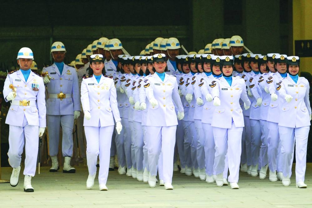 
Uniformed personnel take part in a flag-raising ceremony. 