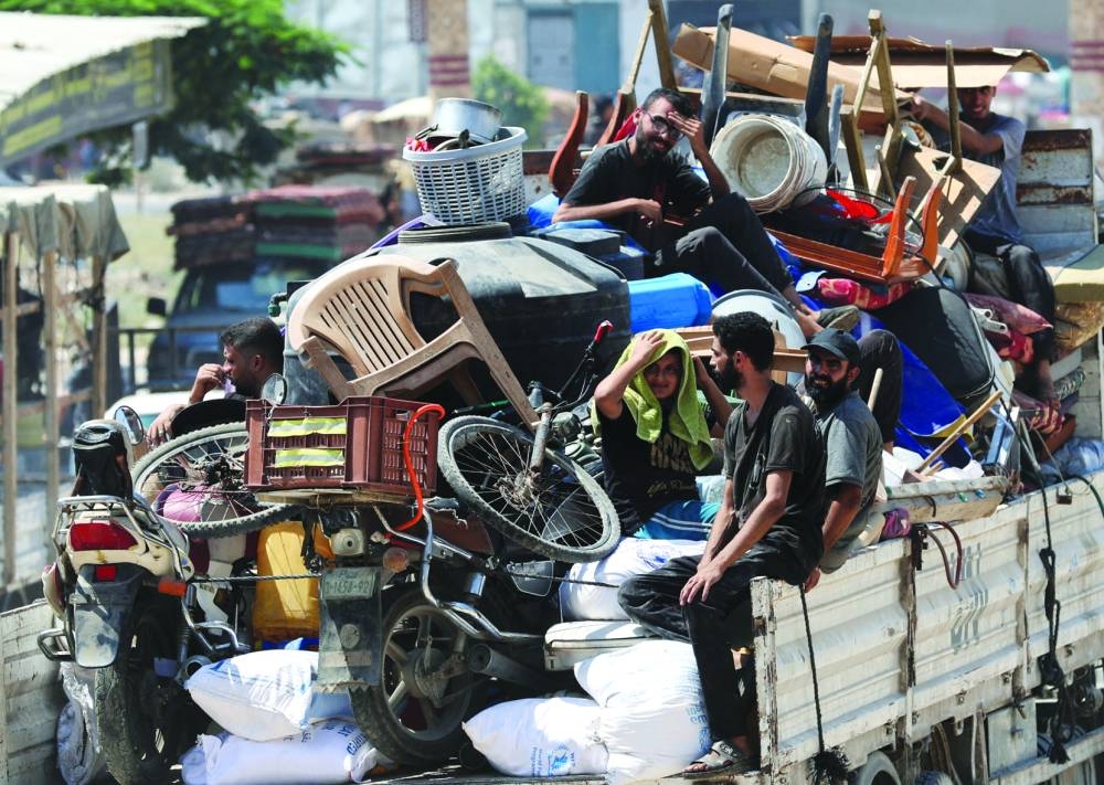 Displaced Palestinians make their way as they flee Maghazi refugee camp following an Israeli evacuation order, in the central Gaza Strip, on Saturday 