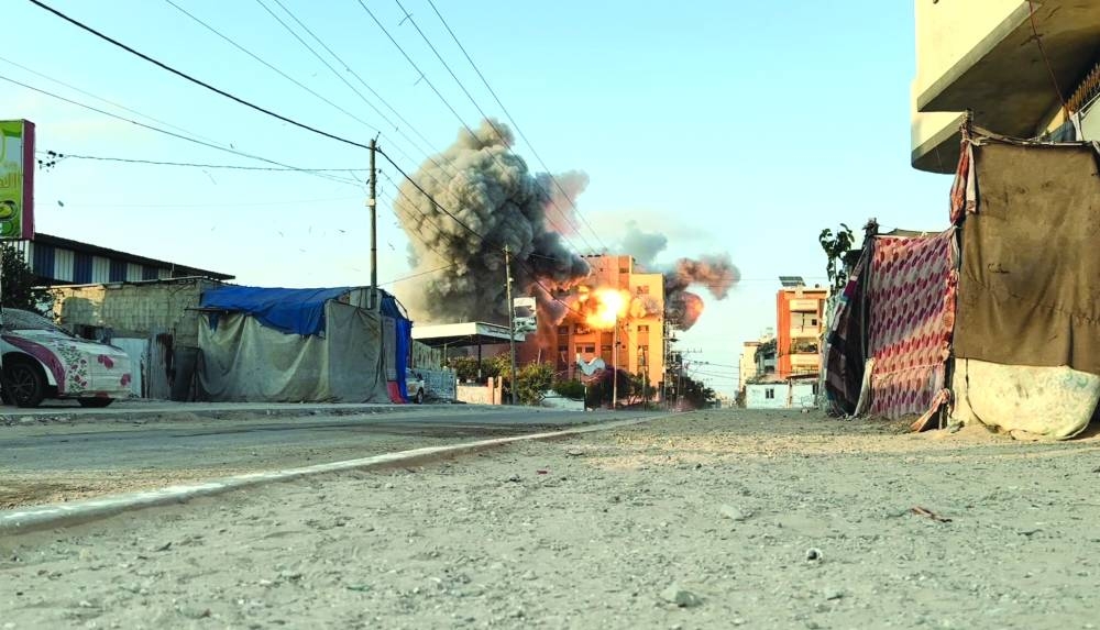 Smoke and flames rise following an Israeli strike on a residential building in Nuseirat in the central Gaza Strip, in this screen grab taken from a video, on Saturday 