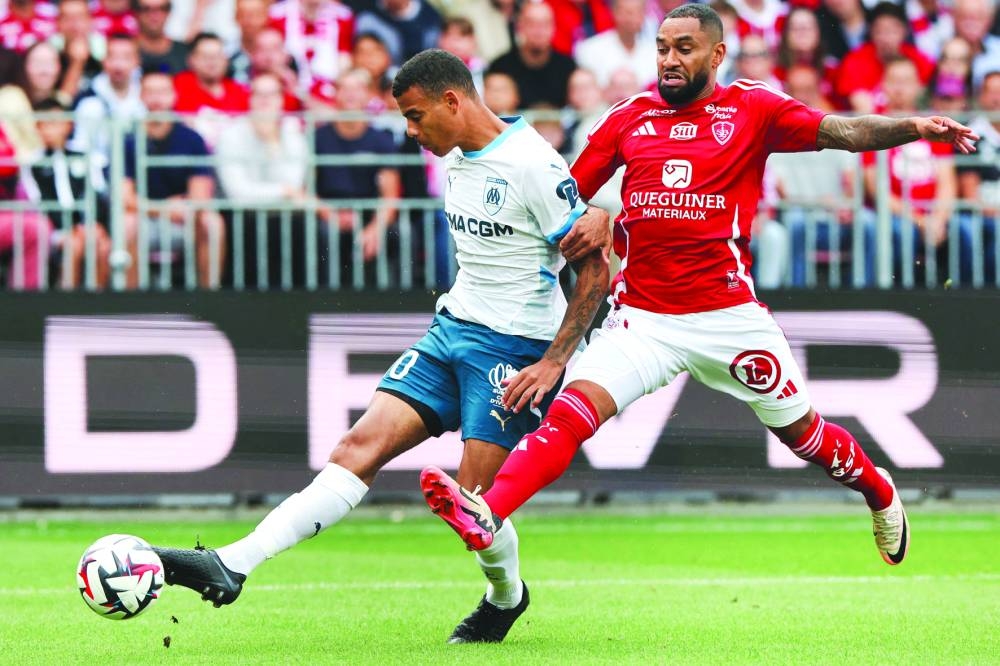 Marseille’s Mason Greenwood (left) and Brest’s Jordan Amavi battle for the ball during the French Ligue 1 match at the Stade Francis-Le Ble in Brest, western France, on Saturday. (AFP)