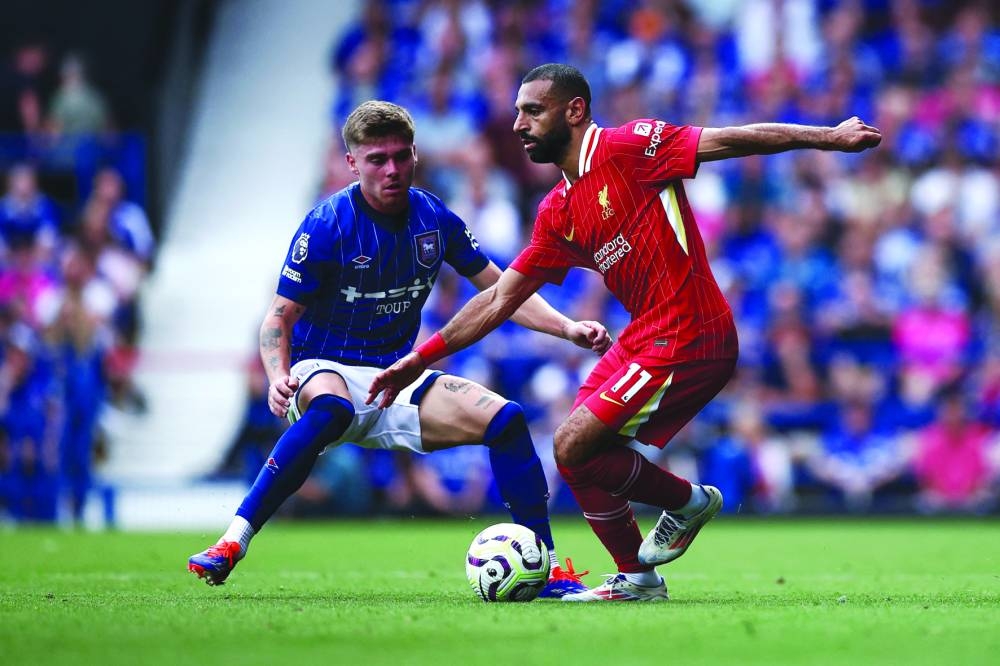 Liverpool’s Mohamed Salah (right) vies for the ball with Ipswich Town’s Leif Davis. (AFP) 