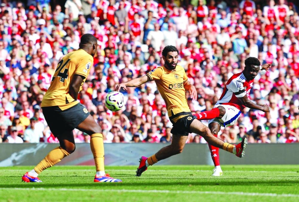 Arsenal’s Bukayo Saka scores against Wolverhampton Wanderers during the Premier League match at the Emirates Stadium in London. (Reuters) 
