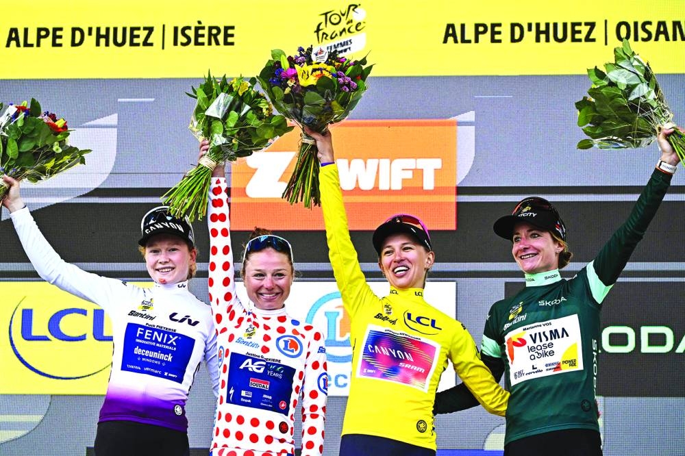 FROM LEFT: Dutch rider Puck Pieterse wearing the best young rider’s white jersey, Belgian rider Justine Ghekiere wearing the climber’s polka dot jersey, overalll leader and first-placed Polish rider Katarzyna Niewiadoma wearing the leader’s yellow jersey and Dutch rider Marianne Vos wearing the best sprinter’s green jersey celebrate on the podium after competing in the 8th and last stage of the third edition of the Women’s Tour de France cycling race, a 149.9km between Le Grand Bornand and the Alpe d’Huez, in L’Alpe d’Huez, south-eastern France, yesterday. (AFP)