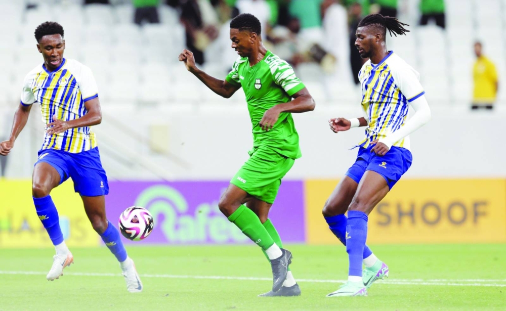 Al Ahli’s French player Sekou Oumar Yansane (centre) battles for ball possession against Al Gharafa during the Ooredoo Stars League clash at Al Thumama Stadium in Doha yesterday. Al Ahli won 1-0.