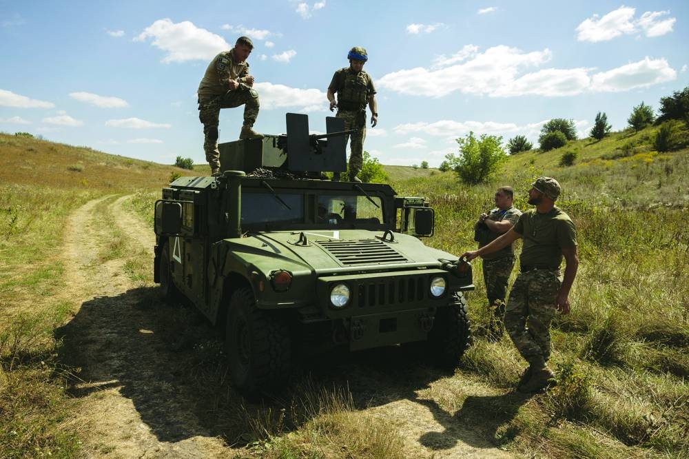 
Soldiers of Ukraine’s 22nd Separate Mechanised Brigade stand atop a Humvee military vehicle during an exercise in the Sumy region near the Russian border on Saturday. (Reuters) 
