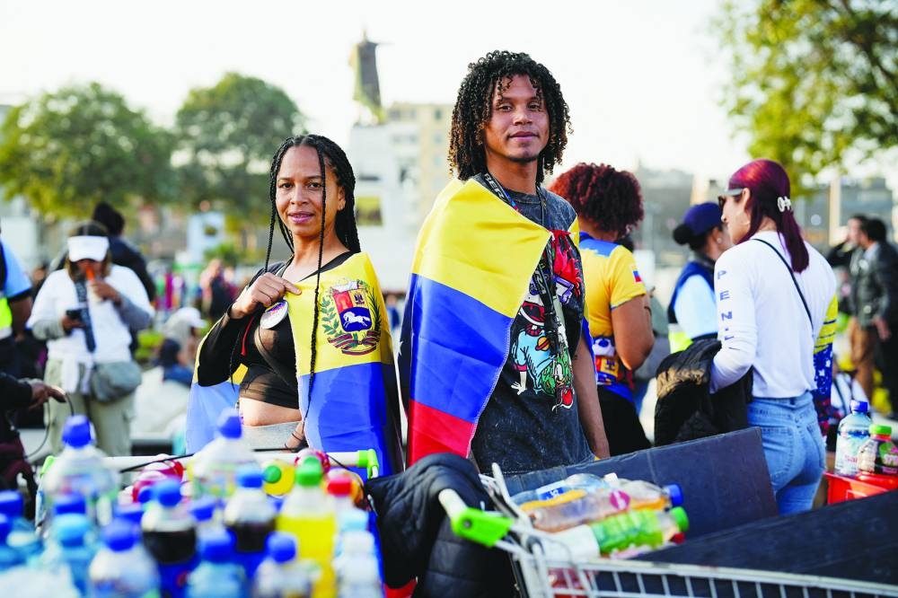 
Venezuelan opposition supporters gather in Lima and Medillin (left). – Reuters 