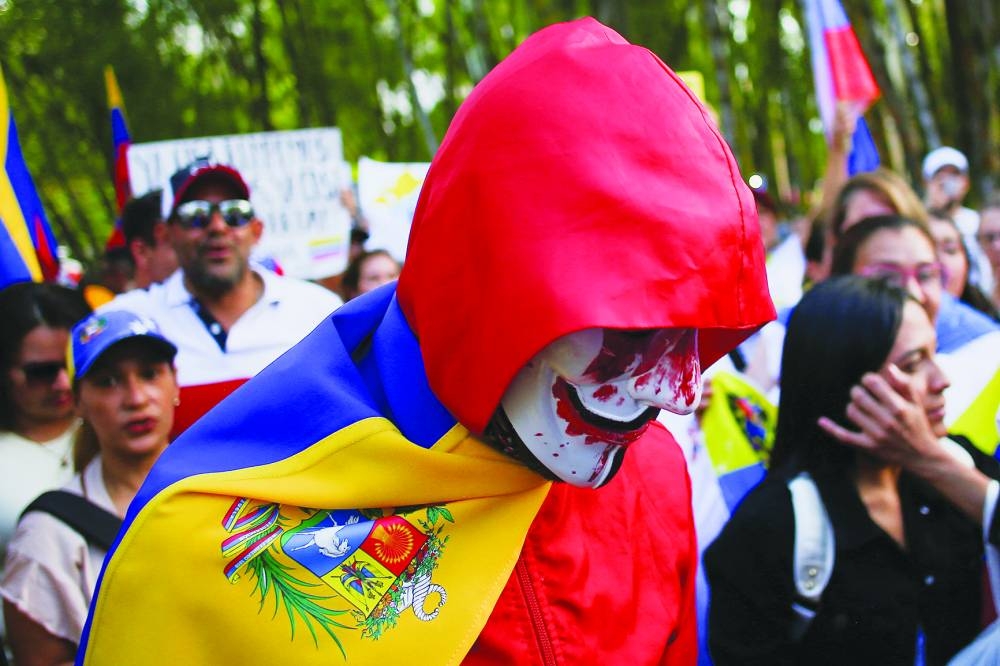Venezuelan opposition supporters in Medellin participate in a global protest. – Reuters