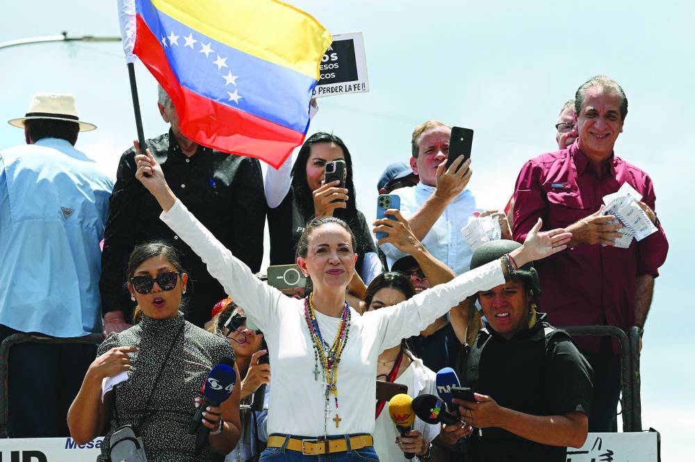 
Venezuelan opposition leader Maria Corina Machado (centre) holds a national flag atop a truck during a protest in Caracas called by the opposition for election ‘victory’ to be recognised. – AFP 