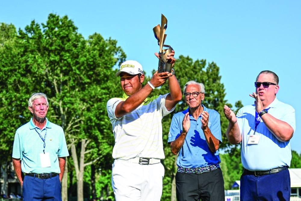 Hideki Matsuyama raises the FedEx Cup TPC Championship trophy to the crowd during the final round of the FedEx St Jude Championship golf tournament at TPC Southwind. (USA TODAY Sports) 