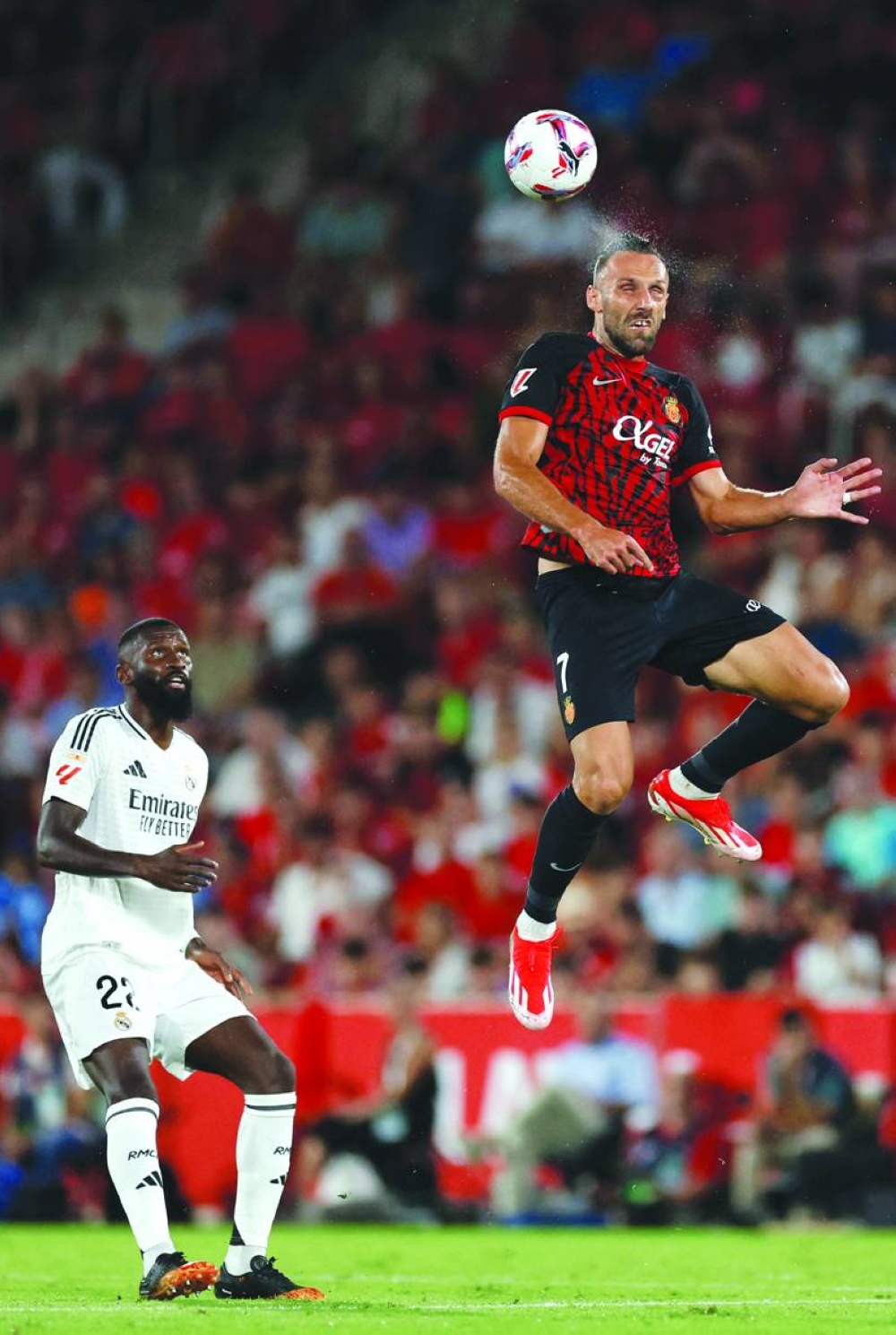 Real Madrid’s Antonio Ruediger looks on as Real Mallorca’s Vedat Muriqi heads the ball during the La Liga match at the Mallorca Son Moix stadium in Palma de Mallorca. (AFP) 