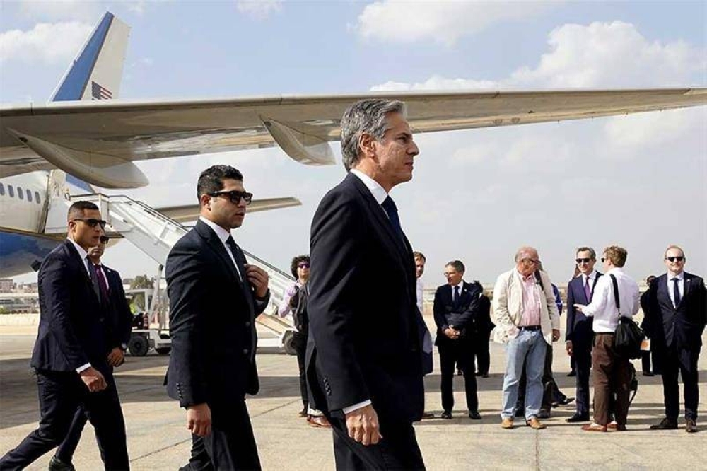  US Secretary of State Antony Blinken walks on the tarmac on arrival at El-Alamein on Egypt's northern coast on Tuesday. AFP