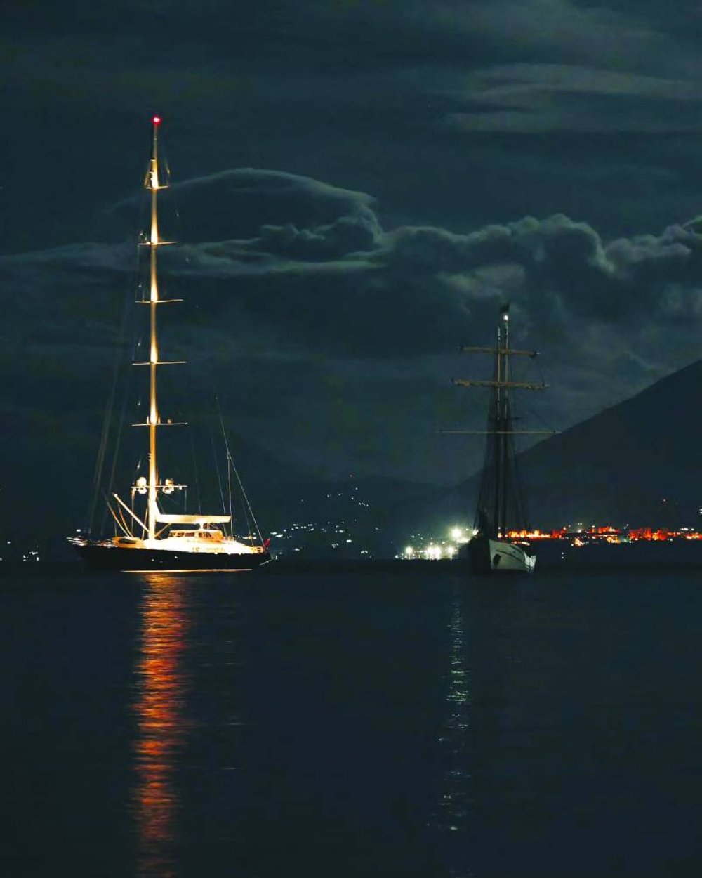 This UGC picture taken on Sunday and released as a courtesy by Fabio la Bianca/BAIA Santa Nicolicchia shows the luxury superyacht called ‘The Bayesian’ off Porticello, Palermo, at night. (AFP)