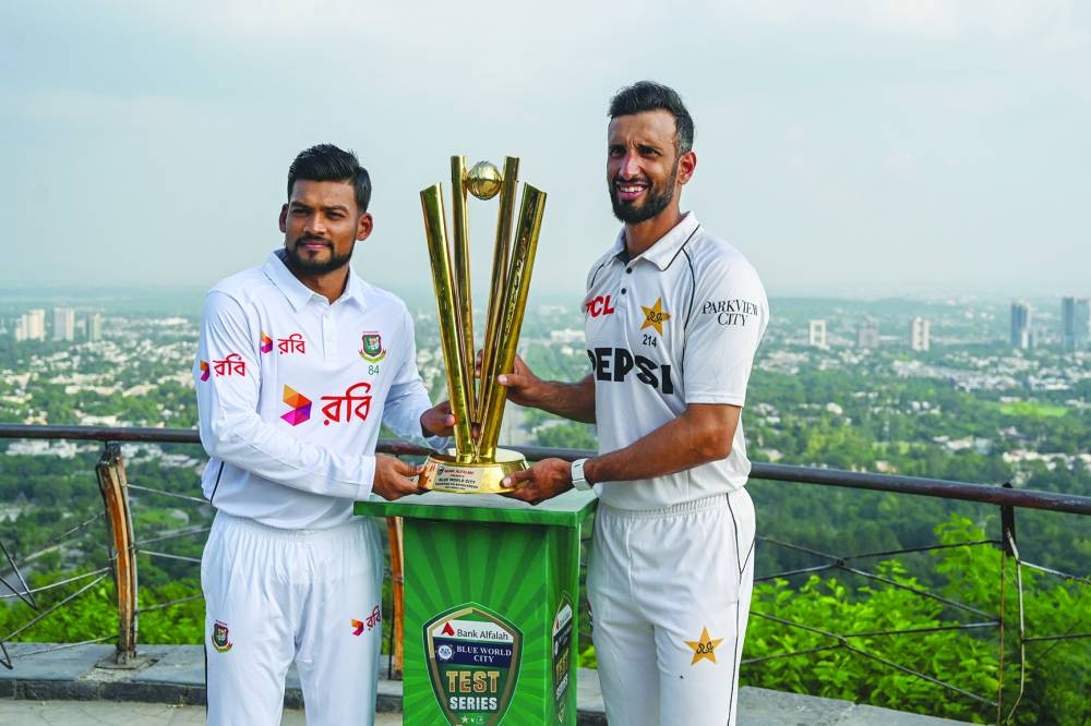 Pakistan’s captain Shan Masood (right) and his Bangladesh’s counterpart Najmul Hossain Shanto (left) pose with the Test series trophy at the Daman-e-Koh view point in Margalla Hills National Park in Islamabad ahead of their first Test. (AFP)