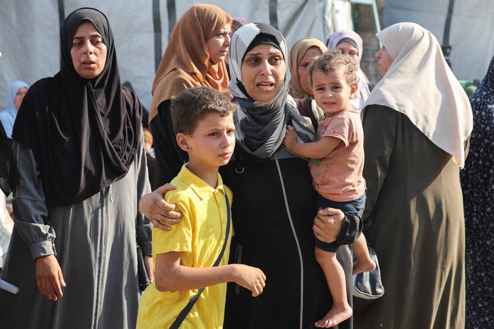 Mourners react near to the bodies of Palestinians killed in Israeli strikes, at Al-Aqsa Martyrs Hospital in Deir Al-Balah in the central Gaza Strip, Tuesday. REUTERS