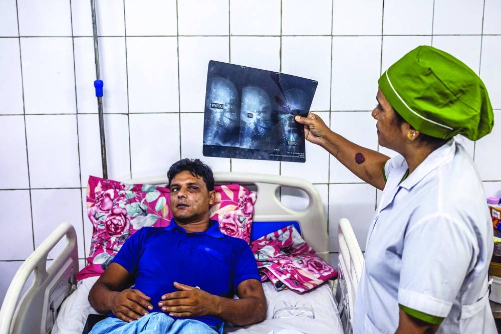 Mohamed Abdul Alim who lost his sight partially as he was wounded by shotgun pellets during the student-led uprising in a bed at National Institute of Ophthalmology and Hospital in Dhaka.