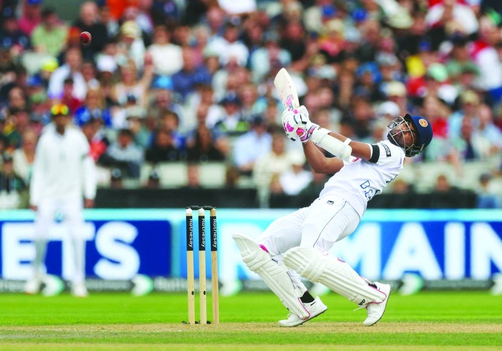 Sri Lanka’s Dinesh Chandimal avoids a bouncer from England’s Mark Wood on the first day of the first Test at Old Trafford in Manchester on Wednesday. (AFP)