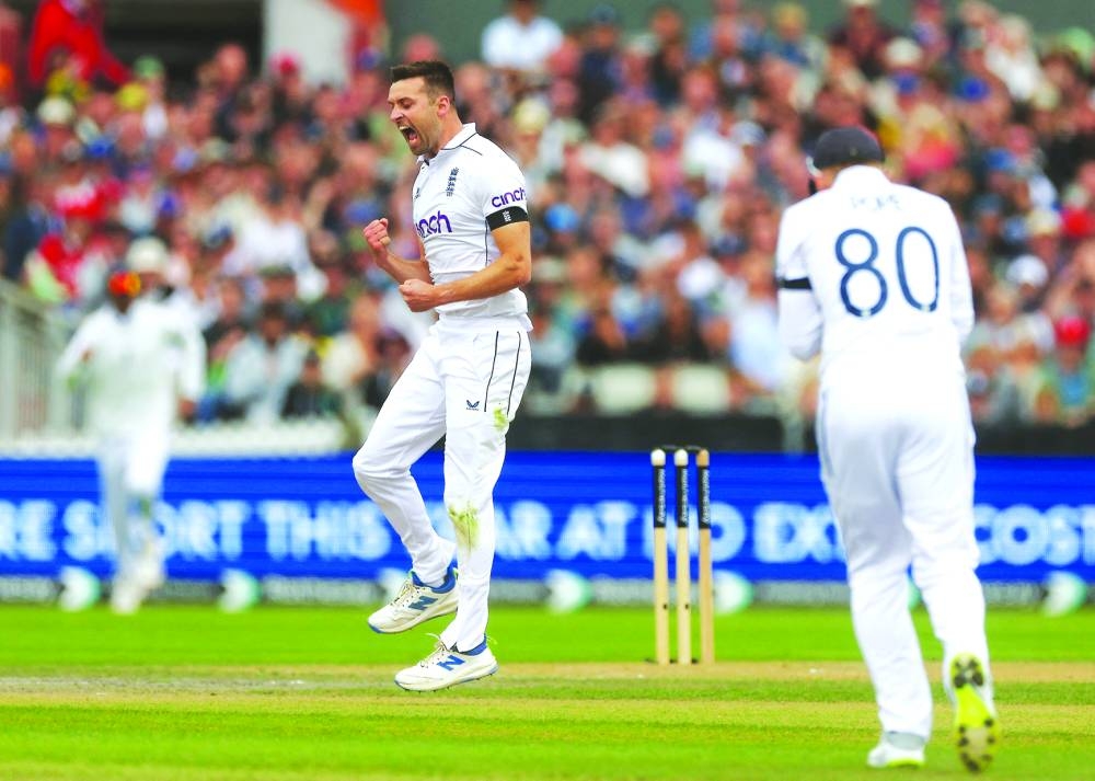 England’s pacer Wood celebrates after taking the wicket of Sri Lanka’s Kusal Mendis. (Reuters)