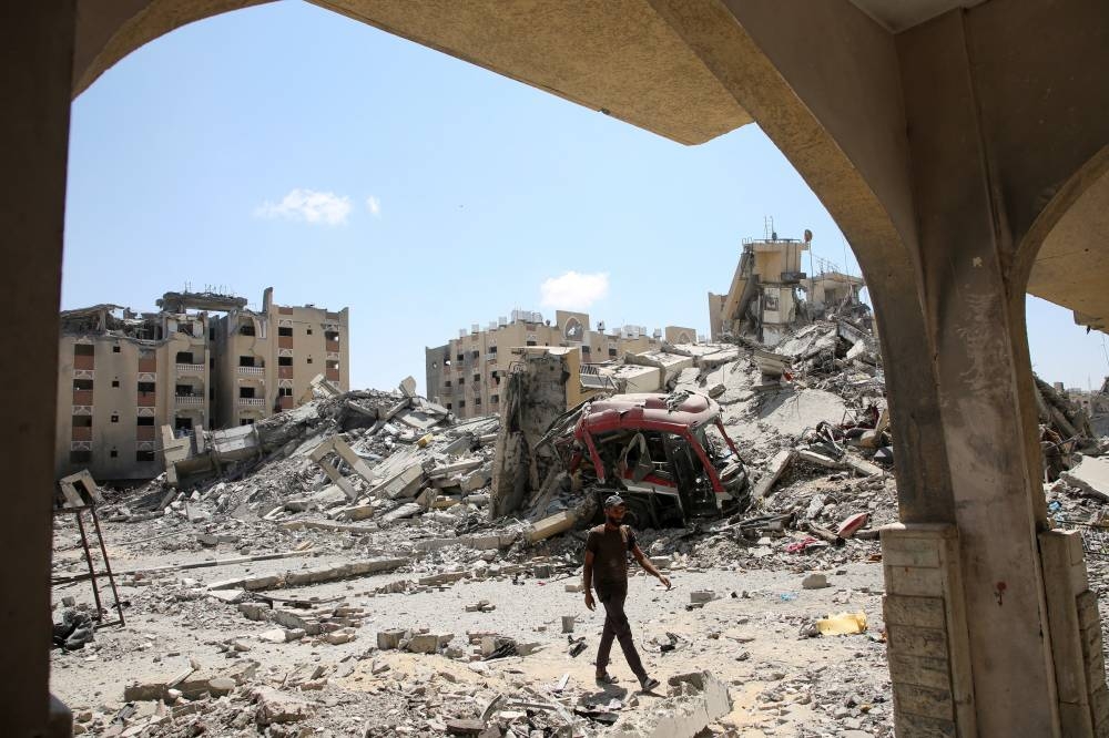 A Palestinian inspects damage in Hamad City, following an Israeli raid, in Khan Younis, in the southern Gaza Strip, on Saturday. REUTERS