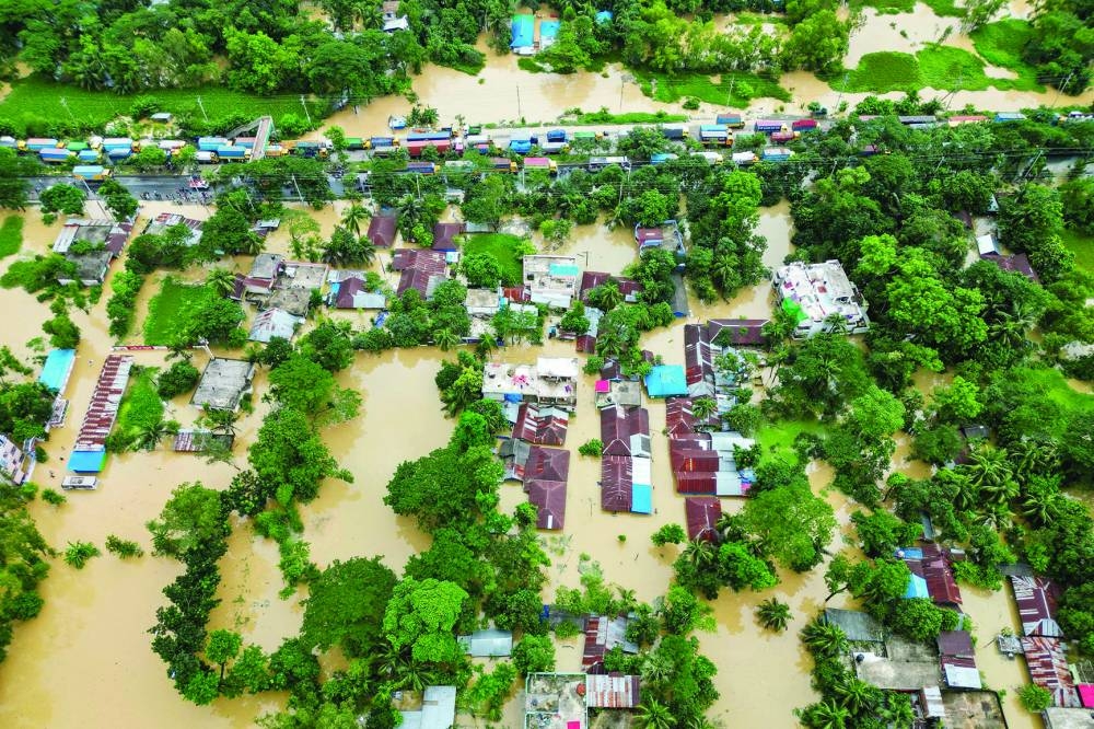 An aerial view shows partially submerged houses after flood in Feni yesterday. 