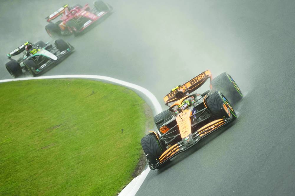 McLaren’s British driver Lando Norris (also inset) drives in front of Mercedes’ British driver Lewis Hamilton (back left) and Ferrari’s Spanish driver Carlos Sainz (back right) during the third practice session at The Circuit Zandvoort, western Netherlands, yesterday, ahead of the Formula One Dutch Grand Prix. (AFP) 