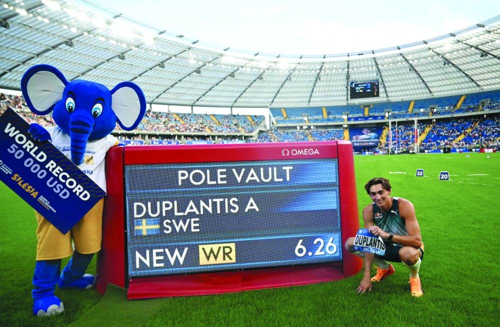 Sweden’s Armand Duplantis poses next to a board displaying his new 6.26m world record after the pole vault event of the Silesia Diamond League in Chorzow, Poland, on Sunday. (AFP)