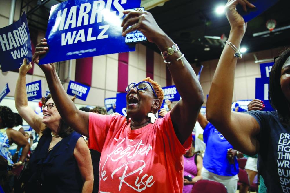 Supporters of Kamala Harris and vice-presidential nominee Minnesota Governor Tim Walz wave campaign signs during the Florida Democratic Party and Team Harris-Walz for Florida Tampa Women’s Rights event at the Victor Crist Community Centre in Tampa. – Reuters