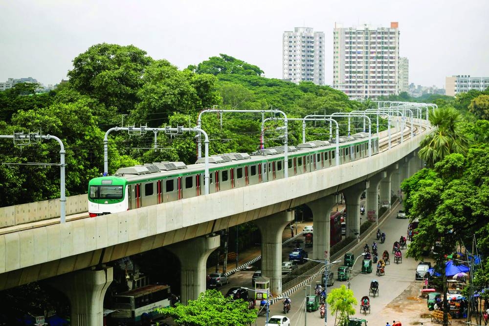 
A metro train rides along a transit line in Dhaka yesterday. – AFP 