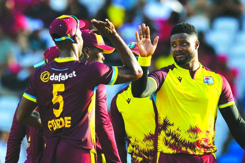 
Romario Shepherd (right) of West Indies celebrates the dismissal of Reeza Hendricks of South Africa during the second T20I in Tarouba, Trinidad and Tobago, on Sunday. (AFP) 