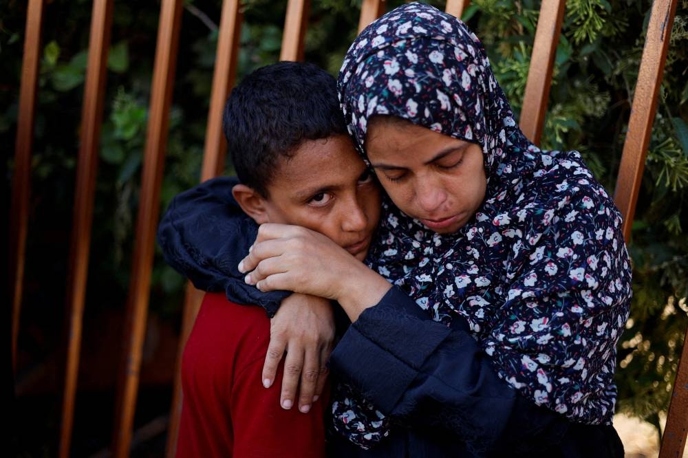 Mourners react during the funeral of Palestinians killed in Israeli strikes, at Nasser hospital, in Khan Younis, southern Gaza Strip Monday. REUTERS