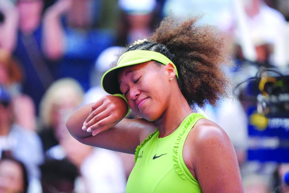 Japan’s Naomi Osaka celebrates after defeating Latvia’s Jelena Ostapenko in their match on Tuesday. (AFP)